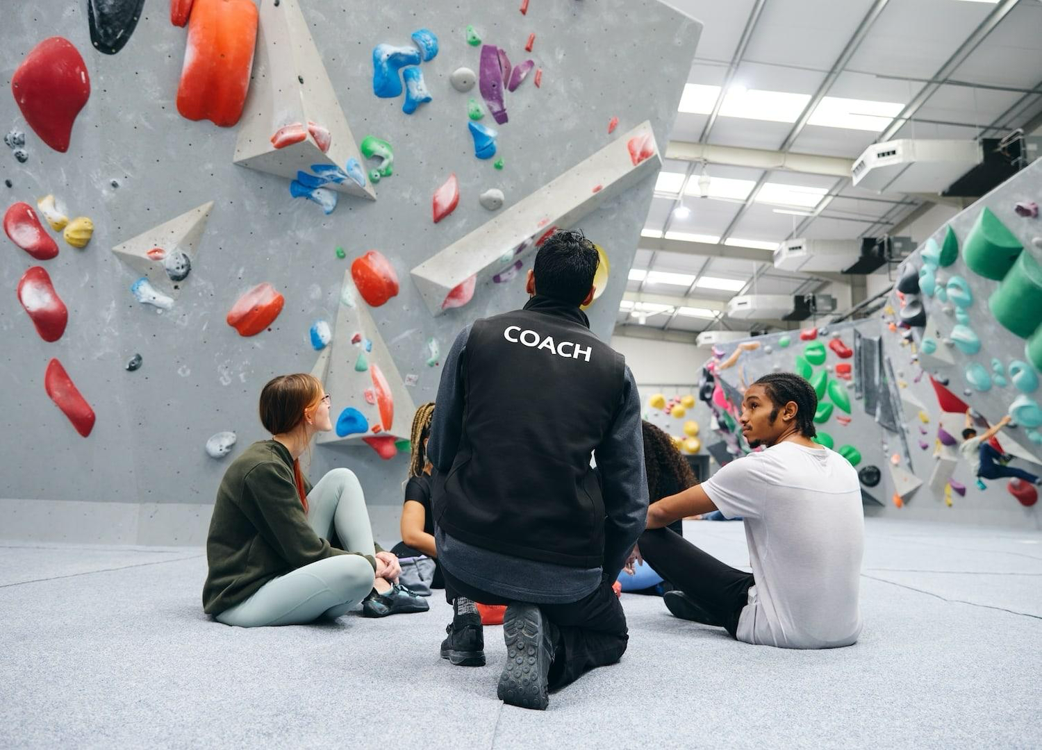Coach working with children in a GCS accredited climbing session